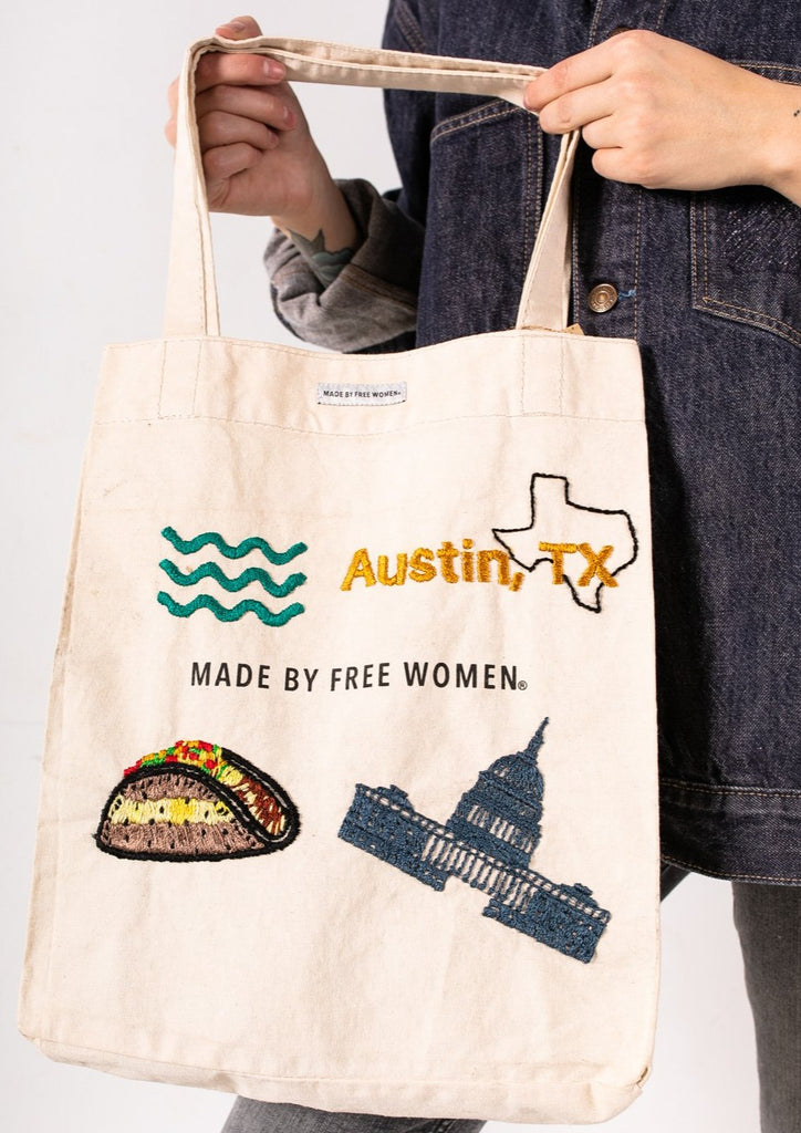 This canvas tote bag is hand-embroiderd by a group of talented makers in Guatemala using traditional techniques. The "Made by Free Women" bag features embroidered designs.